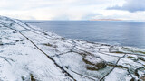 Fototapeta Miasto - Aerial view of snow covered Dunmore Head, Bunaninver and Lackagh by Portnoo in County Donegal, Ireland.