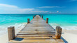 Wooden pier on a white sand beach and sea water during summer vacation time with a blue sky background