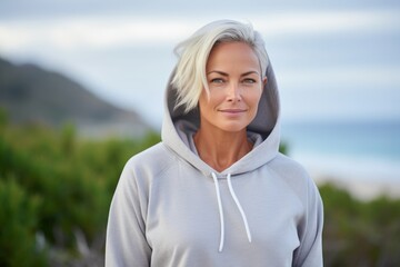 Portrait of a tender woman in her 40s sporting a comfortable hoodie in tropical island background