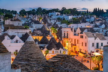 Trulli of Alberobello, Puglia, Italy. town of Alberobello with trulli houses among green plants and flowers