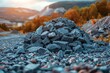 A picturesque pile of rocks set against a blurred autumnal landscape with warm colors