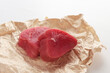 Tuna slices for steaks on white background. Two pieces of tuna on craft paper. Natural omega. Isolated object.