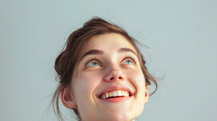 young woman face with looking eyes raised up to the sky and funny expression happy laughing pose isolated on white background