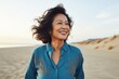 © Markus Schröder - Portrait of a jovial asian woman in her 60s sporting a versatile denim shirt on serene dune landscape background