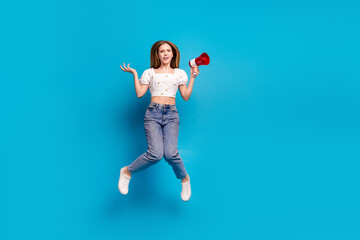 Wall Mural - Full length portrait of lovely girl loudspeaker jump empty space wear top isolated on blue color background
