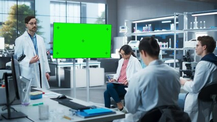 Leinwandbilder - Group of Students Listening to Their Biology Professor Who Uses TV Monitor with Green Screen Template in a Laboratory. Team of Bioengineers Having a Meeting and Discussing Gene Editing Ideas