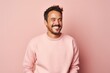 © Markus Schröder - Portrait of a happy man in his 30s wearing a thermal fleece pullover isolated in pastel or soft colors background