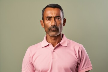 Wall Mural - Portrait of a tender indian man in his 40s wearing a breathable golf polo while standing against pastel or soft colors background