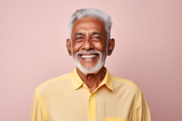 Wall Mural - Portrait of a tender indian man in his 80s sporting a breathable hiking shirt isolated in pastel or soft colors background