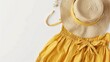 © Orxan - A spring or summer collection display featuring a straw hat and a yellow summer dress on a white background, emphasizing casual women's fashion and accessories