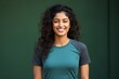Portrait of a grinning indian woman in her 20s sporting a breathable mesh jersey in front of minimalist or empty room background