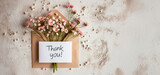 Fototapeta  - Envelope with flowers and a Thank You message on neutral background
