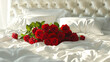 白い寝具のダブルベッドの上の真っ赤な薔薇の花束