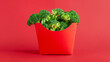 Raw green broccoli florets in red box for french fries. Healthy plant based diet detox superfoods concept