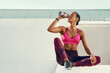 © peopleimages.com - Hydration, fitness and sports woman drinking water for cardio workout, training or running outdoor. Exercise, athlete and female person with bottle for wellness, recovery or thirsty in urban town