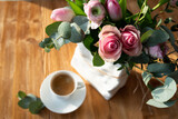 Fototapeta Kosmos - Still life with pink roses and cup of coffee. Background  for mother's day greetings. Top view with short depth of field and space for text.