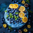 blue celebratory birthday cake with blueberries and lemons