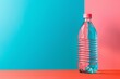 A translucent water bottle pops on a turquoise and coral contrasting base, ideal for standout product placement with copy space.
