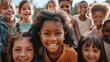 A group of children are smiling and posing for a picture, the children are of different ages and multi ethnic, but they all have one thing in common: they are happy and enjoying the moment