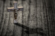 Wooden cross with crucifix and shadow