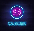 Neon Cancer Sign on brick wall background.