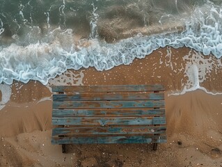 Wall Mural - a wooden table on the beach, with the water next to it 