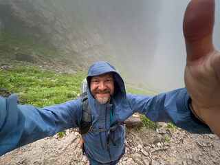 Happy Man with a selfie and the Berchtesgaden Saugasse at the background