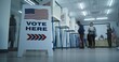 © Framestock - Vote here sign on the floor. Multi ethnic American citizens vote in booths in polling station office. National Election Day in United States. Political races of US presidential candidates. Civic duty.
