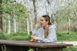 Woman stops to eat some fruit at a rest area during a field trip