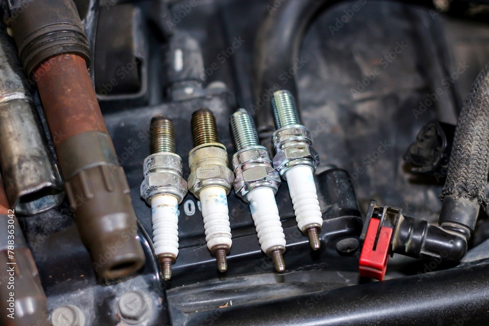 Pictures of new change Spark plug for motorcycle with concept maintenance and repair.