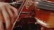 closeup of a violinists fingers on the strings, dynamic angle