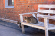 Two cats are relaxing on the bench