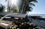 Fototapeta Morze - Beautiful landscape - tropical coconut palms beach with fishing boat. Siargao Island, Philippines.