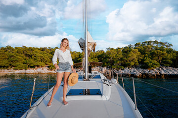 Wall Mural - Luxury travel on the yacht. Young happy woman on boat deck sailing the sea. Yachting in sea.