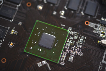 Wall Mural - A brown printed circuit board with a processor chip and video memory strips. Electronic components on the graphics card.