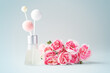 Fragrance diffuser and pink flowers on vintage blue background