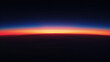 Horizon line on dark black background with a gradient from deep navy to vibrant orange. A beautiful sunset is seen from the sky. 