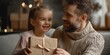 Fathers Day concept. Little girl giving present and greeting card to her happy father, copy space