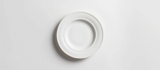 Wall Mural - An empty plate pictured against a white background. Seen from a top-down perspective.