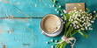 A refreshing image featuring a coffee cup surrounded by lily of the valley flowers on a rustic blue wooden background, signaling the start of a new day