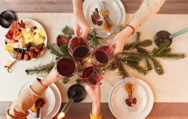 Crop people proposing toast over Christmas table