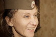 Close-up portrait of a woman in a military cap. Close-up, retro portrait. Vintage historical portrait.