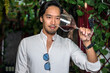 Asian wine taster man holding glass of wine in winery retail shop
