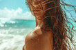 © Jasmina - Portrait of a young beautiful woman with long windy hair on the beach