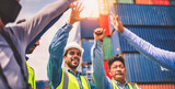 Fototapeta Na sufit - Close-up of Engineering team making pile of hands with cargo container background at sunset. Logistics global import or export shipping industrial concept.