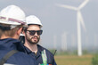 Wind energy technicians with hardhats and safety gear ready to inspect turbines.