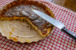 sliced savoury quiche pie on rustic checkered cloth