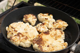 Fototapeta  - Grilled or roasted cauliflower in a pan as a healthy alternative to meat