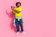 Photo of upset irritated man wear trendy yellow clothes listen discussion news story gossip empty space isolated on pink color background