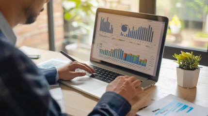 Leinwandbilder - A businessman analyzing financial data on a laptop computer, surrounded by charts and graphs, showcasing strategic decision-making and financial management.